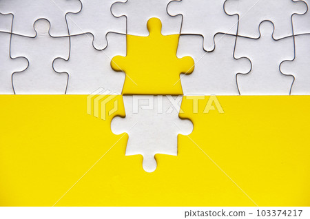 Separated jigsaw puzzle with customizable space for text. Copy space with yellow background. 103374217