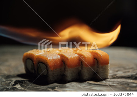 Sushi burning, roasting rolls according to a traditional Japanese recipe 103375044