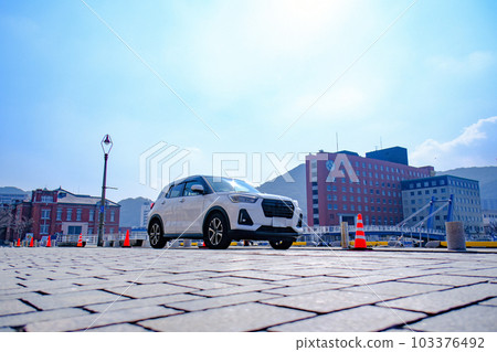 A car driving through the blue sky of Mojiko Retro 103376492