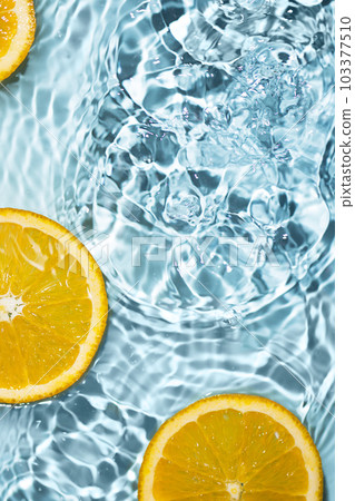 Creative summer background with orange fruit slices in swimming pool water. Summer wallpaper with copy space. 103377510