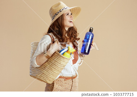 happy trendy female in blouse and shorts isolated on beige 103377715