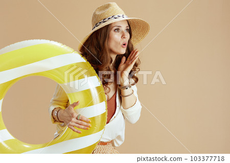 surprised stylish woman in blouse and shorts on beige surprised stylish woman in blouse and shorts on beige 103377718