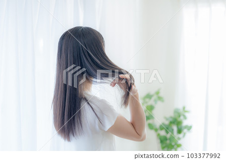 Hair care image: Back view of a woman with long hair Hair care image: Back view of a woman with long hair 103377992