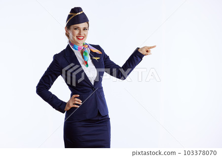 smiling stylish air hostess woman on pointing at copy space smiling stylish air hostess woman on pointing at copy space 103378070