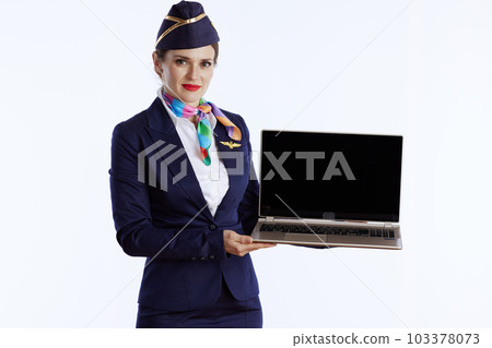 stylish female air hostess on white showing laptop blank screen stylish female air hostess on white showing laptop blank screen 103378073