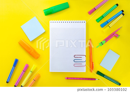 Back to school, drawing. Notebook checkered with pencil for notes to text with paper clips. Near pink, orange, green stationery. Markers, felt-tip pens, sticky note, compasses. Concept of learning. Co Back to school, drawing. Notebook checkered with pencil for notes to text with paper clips. Near pink, orange, green stationery. Markers, felt-tip pens, sticky note, compasses. Concept of learning. Co 103380102