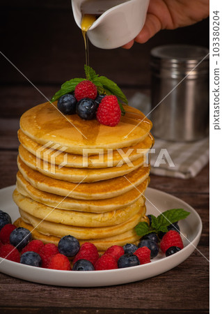 Recipe for maple syrup pancakes with raspberry and blueberry filling 103380204
