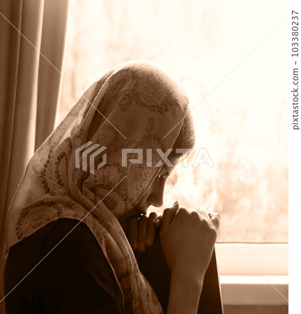 Girl with a book by the window Girl with a book by the window 103380237