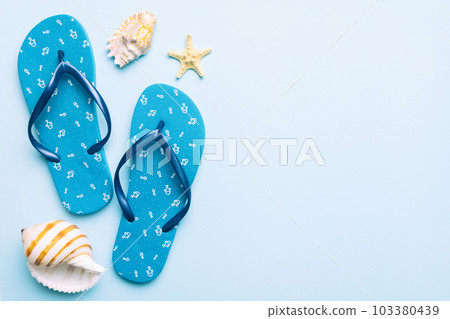 Flat lay composition with flip flops and seashell on colored background. Space for text top view 103380439