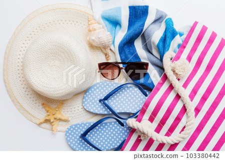 beach accessories flat lay top view on colored background Summer travel concept. Bag with starfish and sea shell. Top view beach accessories flat lay top view on colored background Summer travel concept. Bag with starfish and sea shell. Top view 103380442