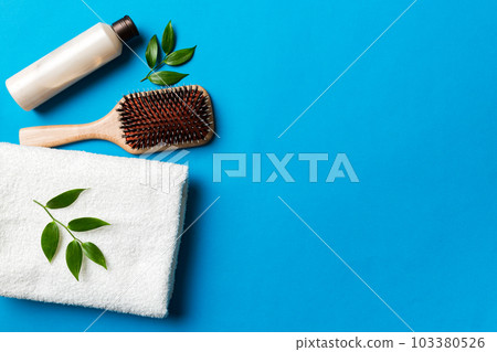 cosmetic for hair care, cream and towel on a colored background top view. flat lay 103380526