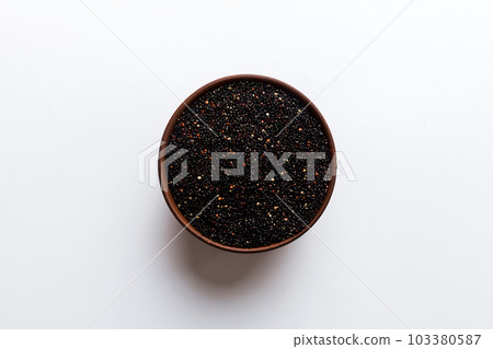 quinoa seeds in bowl on colored background. Healthy kinwa in small bowl. Healthy superfood quinoa seeds in bowl on colored background. Healthy kinwa in small bowl. Healthy superfood 103380587