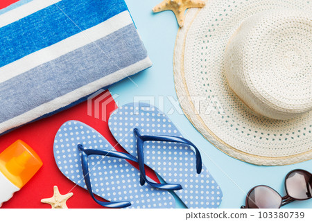 Beach accessories straw hat and seashell on colored table. Summer concept background 103380739