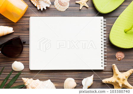 Blank writing book with summer beach accessories on background, copy space. Flat lay with copy space 103380740