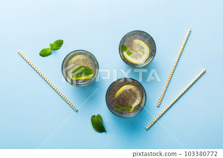 Healthy breakfast or morning with chia seeds lemon and mint on table background, vegetarian food, diet and health concept. Chia pudding with lemon and mint 103380772