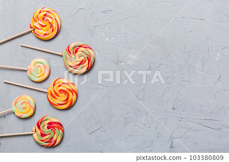 Set of colorful lollipops on colored background. Summer concept. Party Happy Birthday or Minimalist Concept Set of colorful lollipops on colored background. Summer concept. Party Happy Birthday or Minimalist Concept 103380809