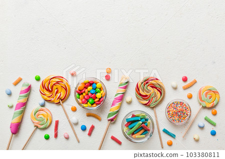 Tasty appetizing Party Accessories Happy Birthday Sweet. Different types of candies on colored background, copy space. Colorful birthday party background Tasty appetizing Party Accessories Happy Birthday Sweet. Different types of candies on colored background, copy space. Colorful birthday party background 103380811