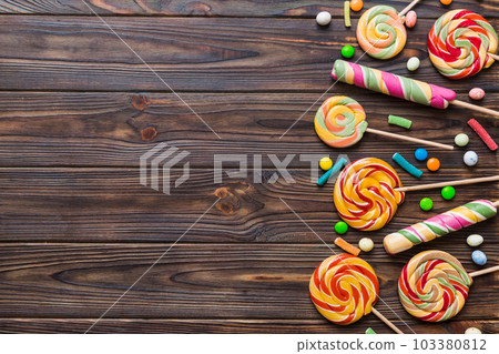 Tasty appetizing Party Accessories Happy Birthday Sweet. Different types of candies on colored background, copy space. Colorful birthday party background Tasty appetizing Party Accessories Happy Birthday Sweet. Different types of candies on colored background, copy space. Colorful birthday party background 103380812