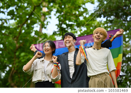 Happy young LGBT friends with rainbow heart celebrating gay pride, enjoying outdoor activities at outdoor Happy young LGBT friends with rainbow heart celebrating gay pride, enjoying outdoor activities at outdoor 103381469