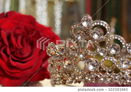 Rose and Tiara with Perfume and Jewelry in Background Rose and Tiara with Perfume and Jewelry in Background 103381665