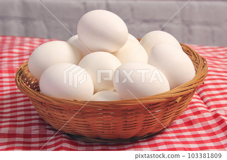 Basket of Farm Fresh Eggs on Red and White Checkered Fabric 103381809