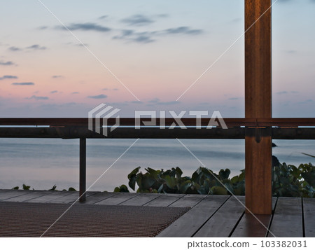 Yomitan Village, Okinawa Prefecture. Banta Cafe where you can see the beautiful sunset. Yomitan Village, Okinawa Prefecture. Banta Cafe where you can see the beautiful sunset. 103382031