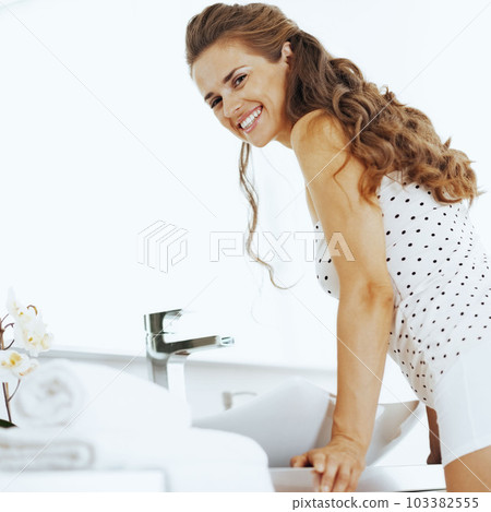 happy young woman in bathroom 103382555