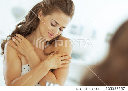 relaxed young woman in bathroom 103382567