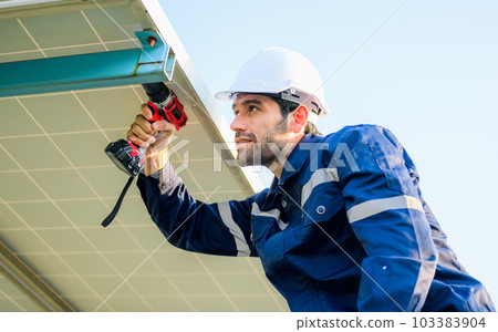 Male technician worker installing solar panels at solar cell farm Male technician worker installing solar panels at solar cell farm 103383904