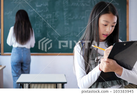 Student studying and reading textbook with happiness in classroom 103383945