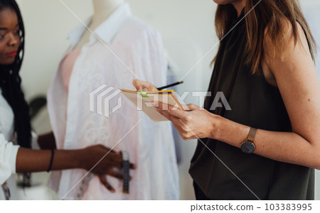 Happy Couple of fashion designer working together in workshop studio 103383995
