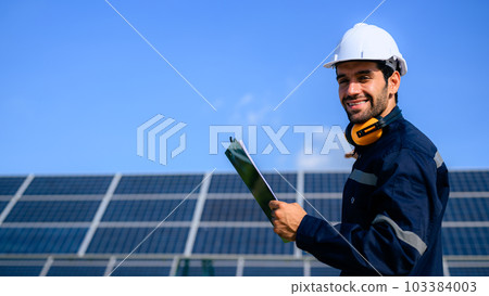 Engineer worker portrait with solar panel at solar farm 103384003