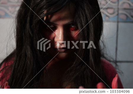 Scary woman in white dress with bloodstain after murder, Halloween concept 103384096