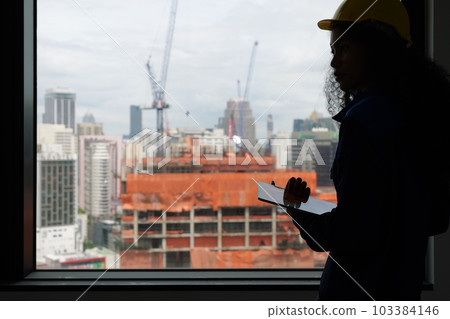 Portrait of engineer foreman with safety helmet and vest on building site Portrait of engineer foreman with safety helmet and vest on building site 103384146