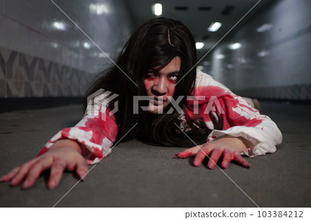 Scary woman in white dress with bloodstain after murder, Halloween concept Scary woman in white dress with bloodstain after murder, Halloween concept 103384212
