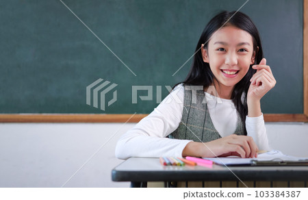 Student studying and reading textbook with happiness in classroom 103384387