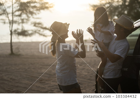 Happy Asian family travel on beach on holiday Happy Asian family travel on beach on holiday 103384432