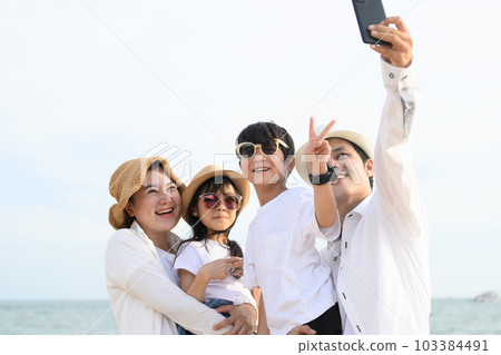 Happy family enjoying to travel on beach on holiday vacation 103384491