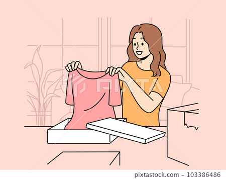 Smiling woman unpack orders at home shopping online  103386486