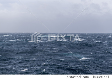 Beautiful seascape - waves and sky with clouds with beautiful lighting. Stormy sea, Bad weather. Gale. Rough sea. Beautiful seascape - waves and sky with clouds with beautiful lighting. Stormy sea, Bad weather. Gale. Rough sea. 103391451