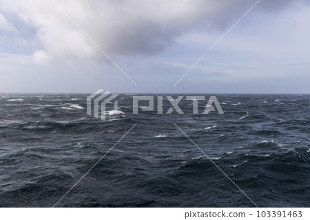 Beautiful seascape - waves and sky with clouds with beautiful lighting. Stormy sea, Bad weather. Gale. Rough sea. Beautiful seascape - waves and sky with clouds with beautiful lighting. Stormy sea, Bad weather. Gale. Rough sea. 103391463