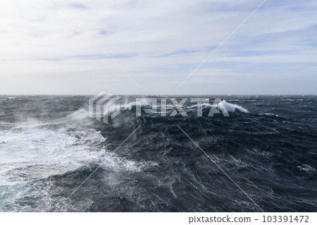 Beautiful seascape - waves and sky with clouds with beautiful lighting. Stormy sea, Bad weather. Gale. Rough sea. Beautiful seascape - waves and sky with clouds with beautiful lighting. Stormy sea, Bad weather. Gale. Rough sea. 103391472