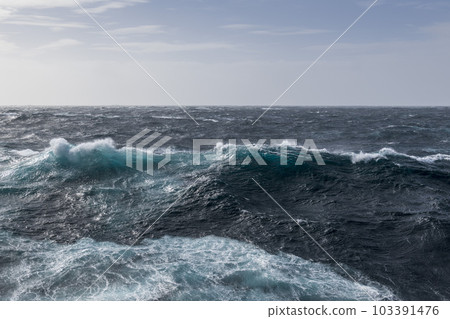 Beautiful seascape - waves and sky with clouds with beautiful lighting. Stormy sea, Bad weather. Gale. Rough sea. Beautiful seascape - waves and sky with clouds with beautiful lighting. Stormy sea, Bad weather. Gale. Rough sea. 103391476
