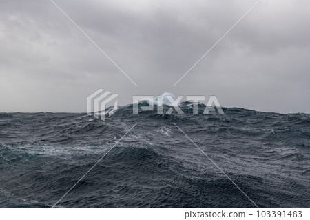 Beautiful seascape - waves and sky with clouds with beautiful lighting. Stormy sea, Bad weather. Gale. Rough sea. Beautiful seascape - waves and sky with clouds with beautiful lighting. Stormy sea, Bad weather. Gale. Rough sea. 103391483