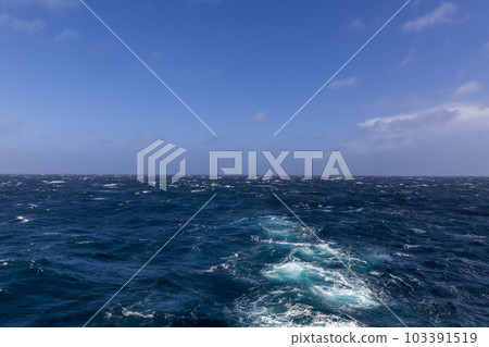 Beautiful seascape - waves and sky with clouds with beautiful lighting. Stormy sea, Bad weather. Gale. Rough sea. Beautiful seascape - waves and sky with clouds with beautiful lighting. Stormy sea, Bad weather. Gale. Rough sea. 103391519