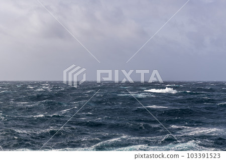 Beautiful seascape - waves and sky with clouds with beautiful lighting. Stormy sea, Bad weather. Gale. Rough sea. Beautiful seascape - waves and sky with clouds with beautiful lighting. Stormy sea, Bad weather. Gale. Rough sea. 103391523