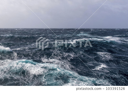 Beautiful seascape - waves and sky with clouds with beautiful lighting. Stormy sea, Bad weather. Gale. Rough sea. Beautiful seascape - waves and sky with clouds with beautiful lighting. Stormy sea, Bad weather. Gale. Rough sea. 103391526