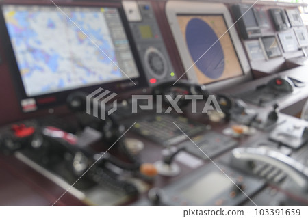 Navigational control panel and VHF radio. Working on the ship's navigational bridge. Blurred image. 103391659