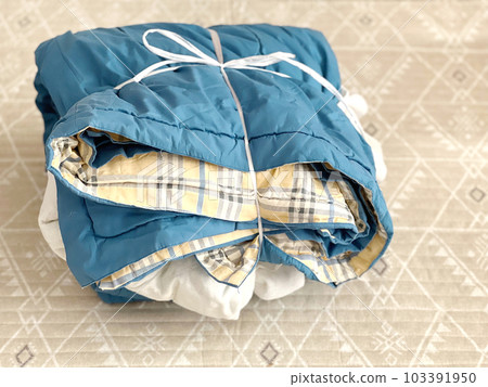 a light blanket tied with a string a light blanket tied with a string 103391950