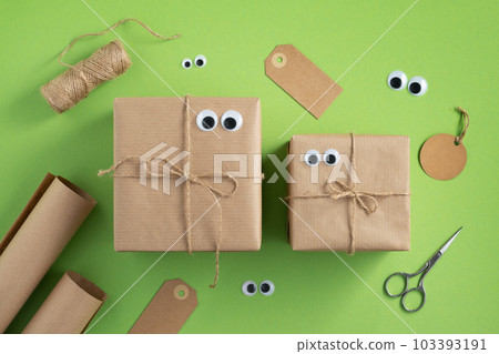 Funny gift boxes with eyes and wrapping materials. 103393191